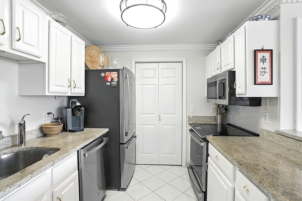150 Staniford Street, Unit 1009 Boston, MA 02114 - Photo 13 of 25 a kitchen with a sink stove and refrigerator