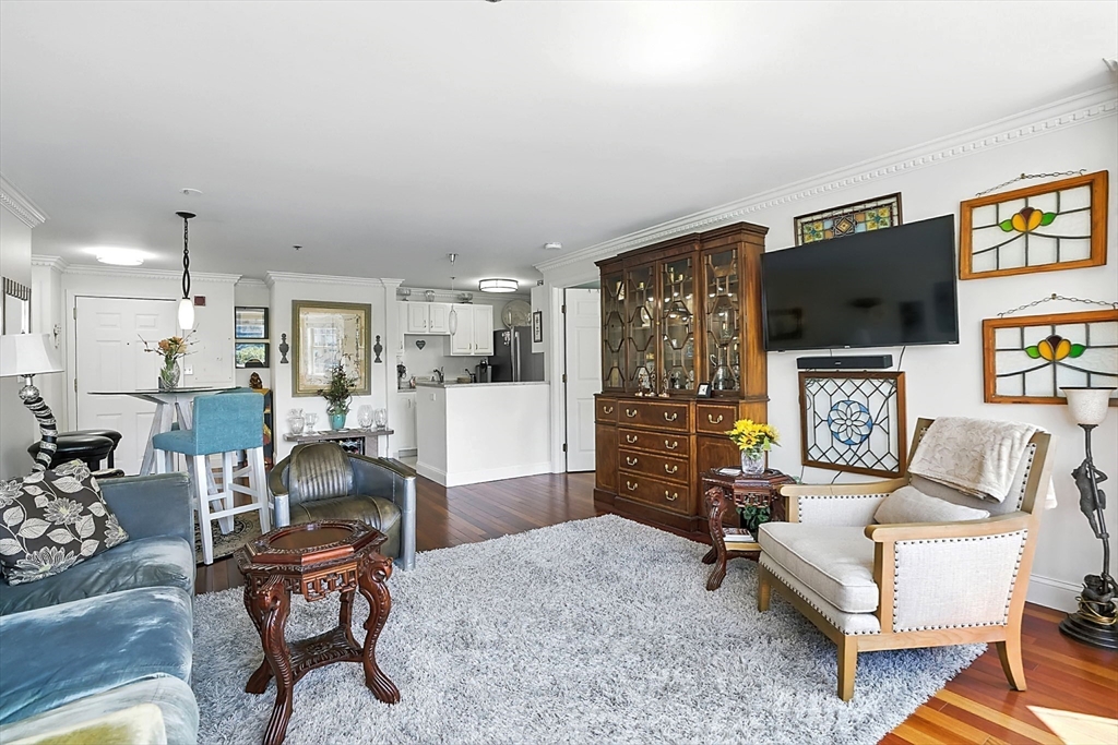 150 Staniford Street, Unit 1009 Boston, MA 02114 - Photo 16 of 25 a living room with fireplace furniture and a flat screen tv