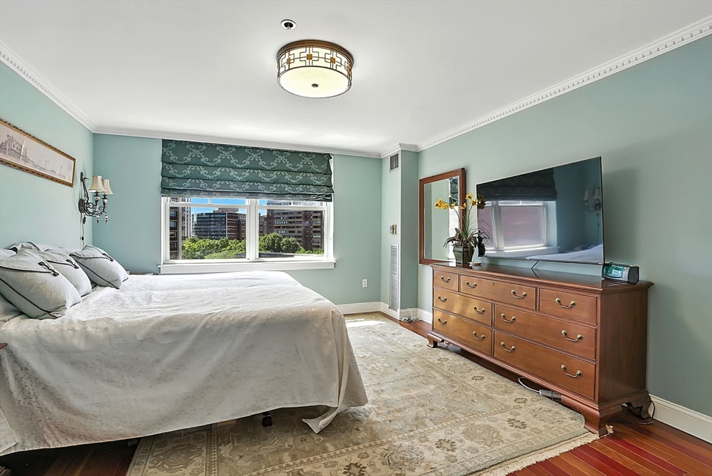 150 Staniford Street, Unit 1009 Boston, MA 02114 - Photo 18 of 25 a bedroom with a large bed and a dresser