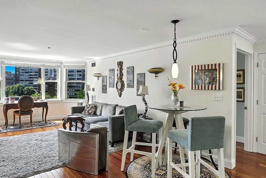 150 Staniford Street, Unit 1009 Boston, MA 02114 - Photo 3 of 25 a living room with furniture a chandelier and a dining table