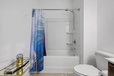 a bathroom with a toilet and a bathtub