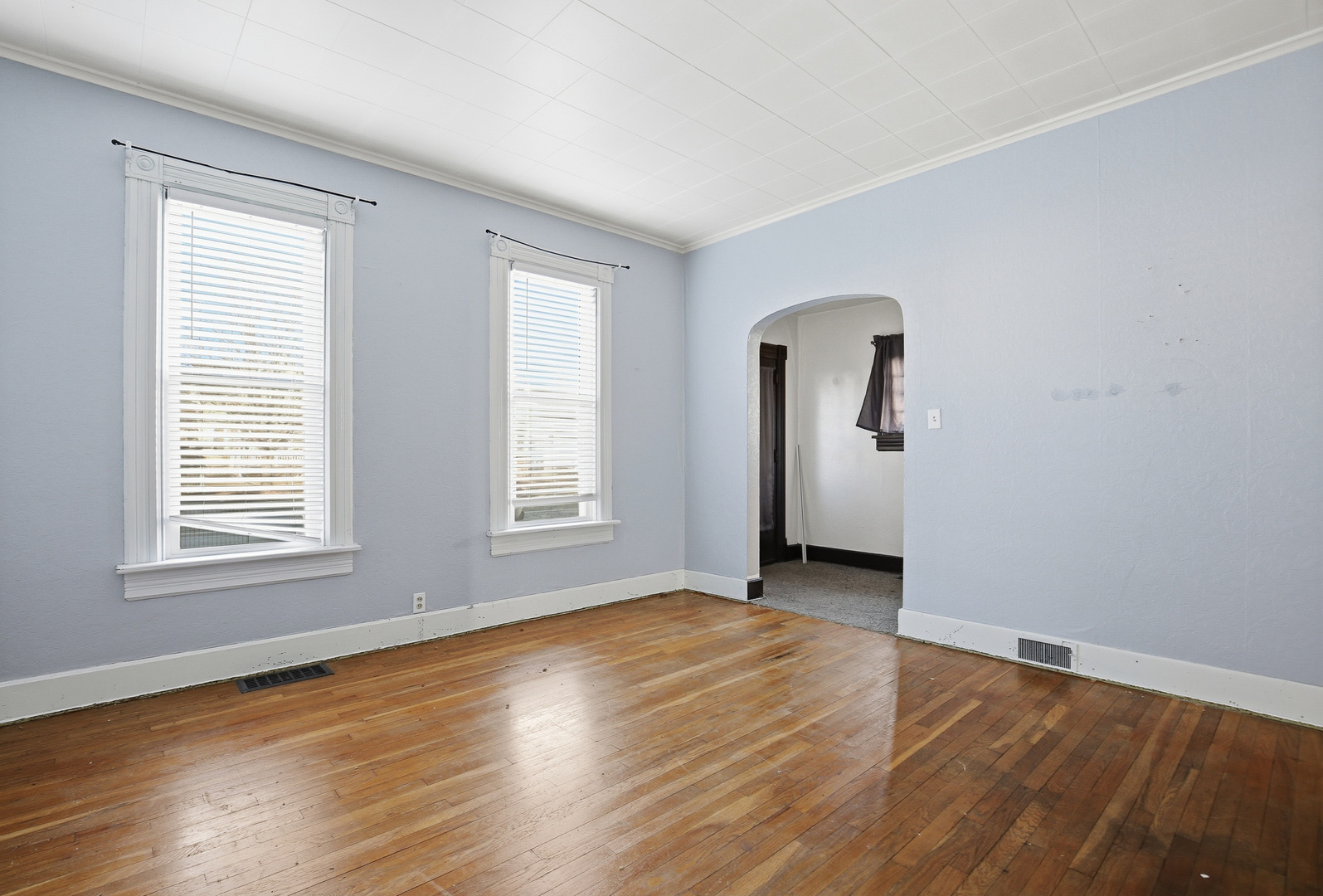 2115 West 4th Street Davenport, IA 52802 - Photo 10 of 24 an empty room with wooden floor and windows