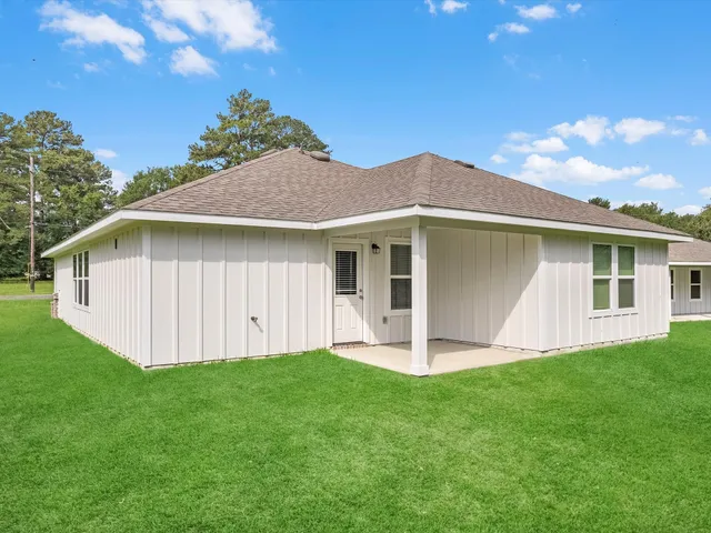 a front view of a house with a yard and porch