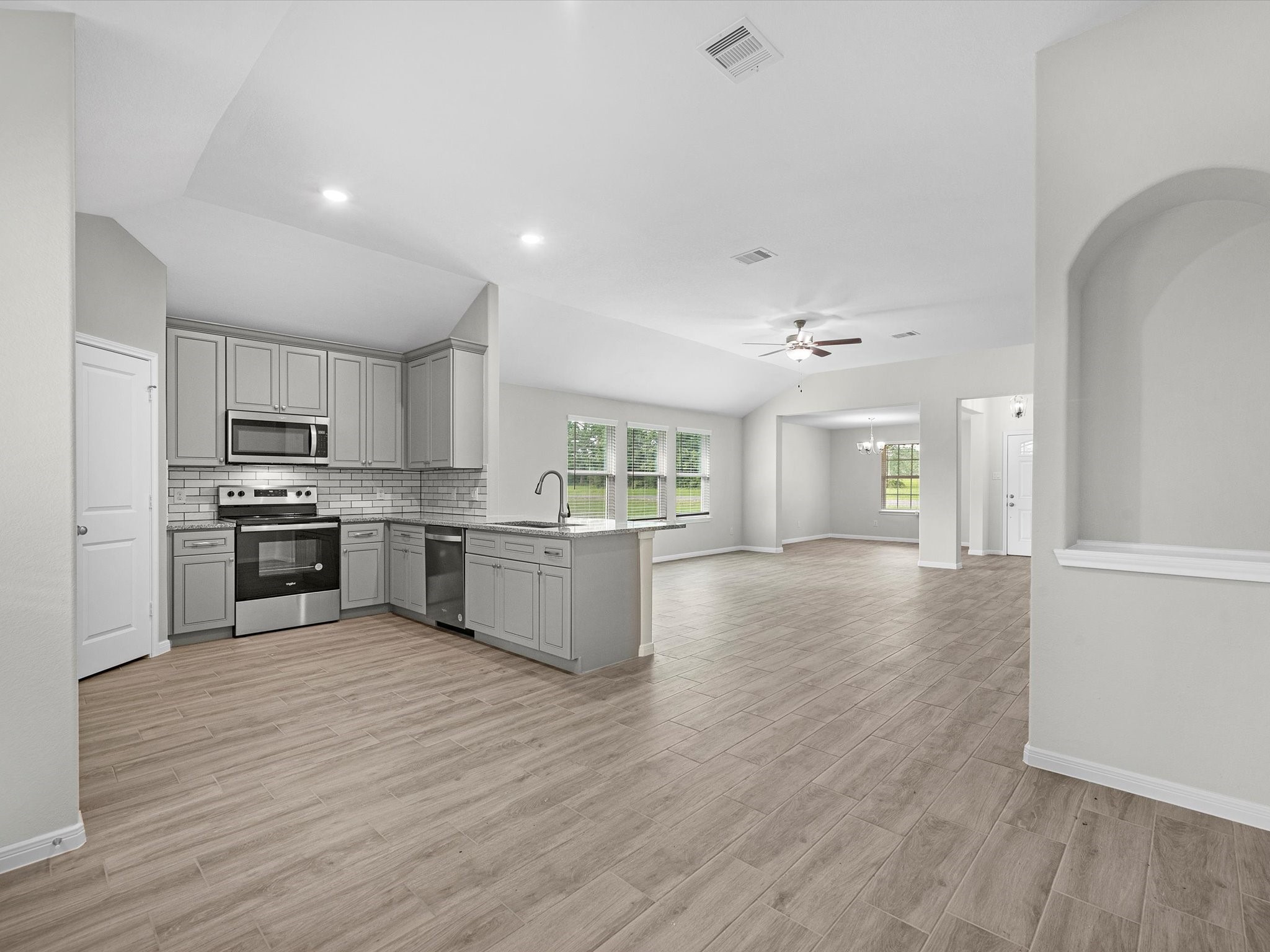 46 Fairway Drive Trinity, TX 75862 - Photo 10 of 26 a kitchen with stainless steel appliances granite countertop a stove top oven a sink dishwasher and a refrigerator with wooden floor