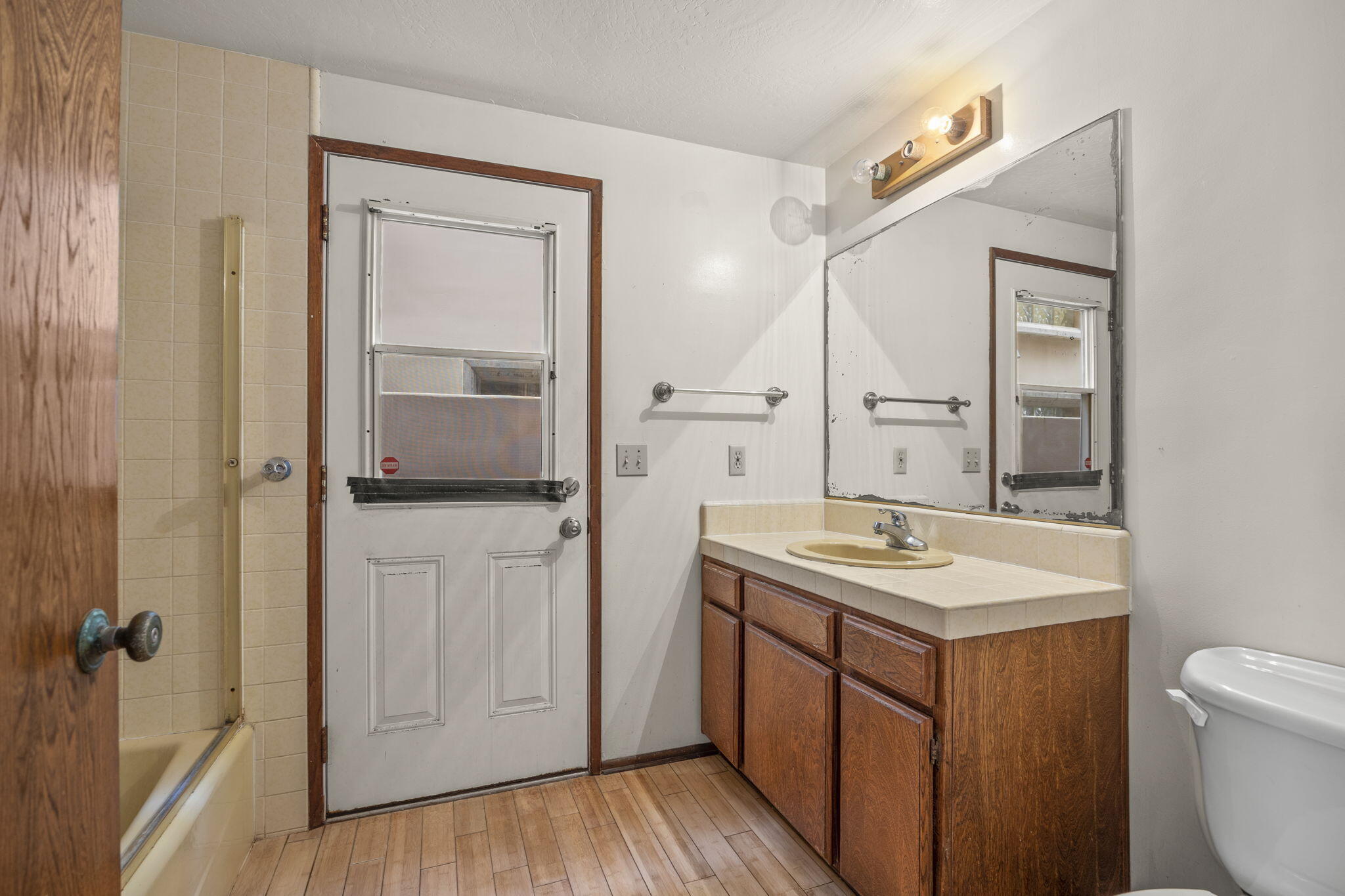 6726 Breakers Way Ventura, CA 93001 - Photo 32 of 42 a bathroom with a sink a toilet and a mirror