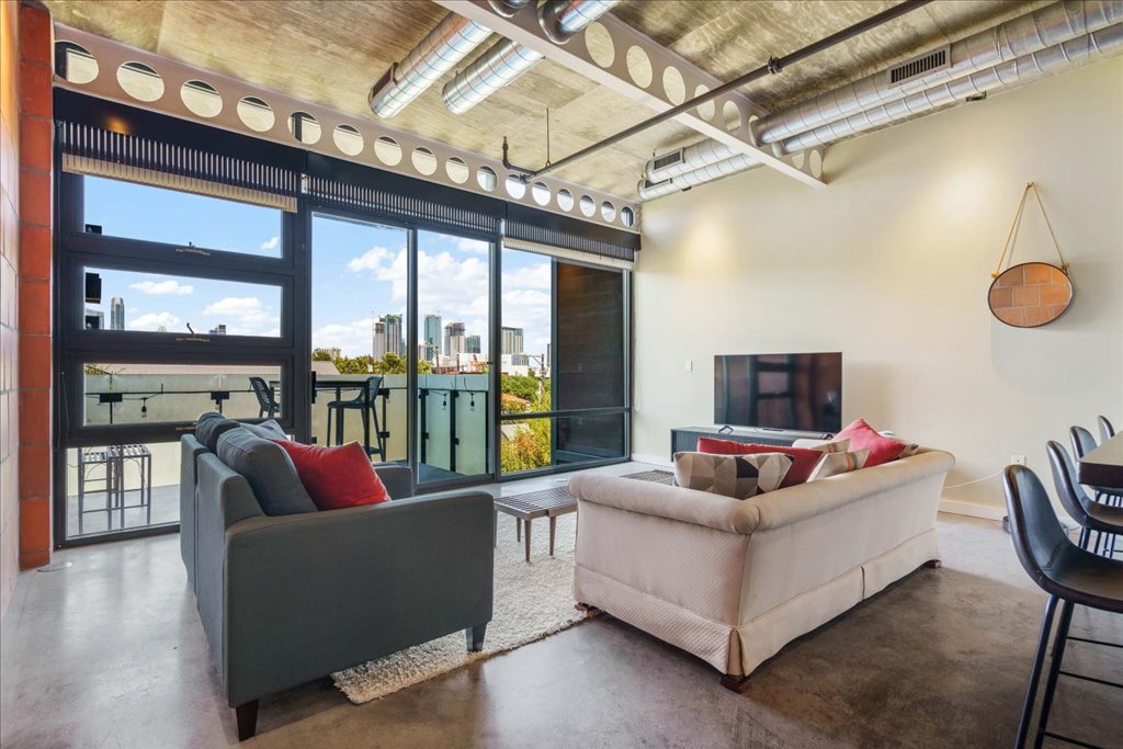 Living area featuring a high concrete ceiling and finished concrete flooring