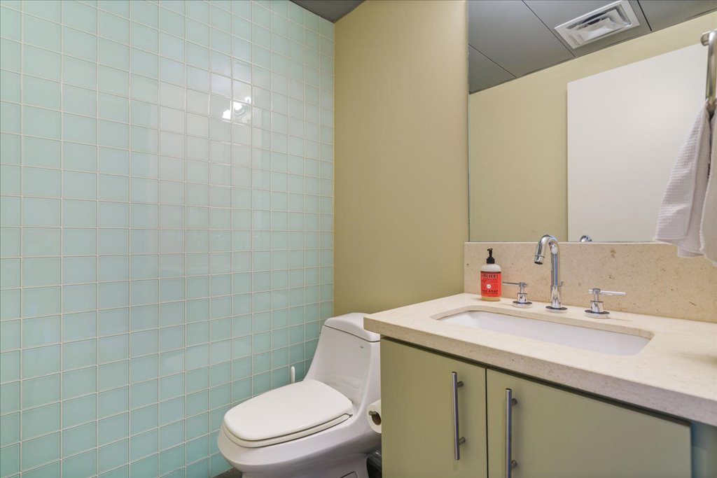 1401 Eva Street, Unit 302 Austin, TX 78704 - Photo 11 of 15 Half bath with vanity and toilet