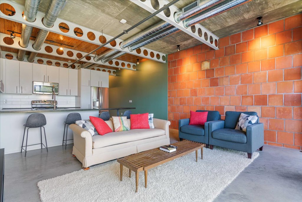 1401 Eva Street, Unit 302 Austin, TX 78704 - Photo 3 of 15 Living room with concrete flooring and track lighting