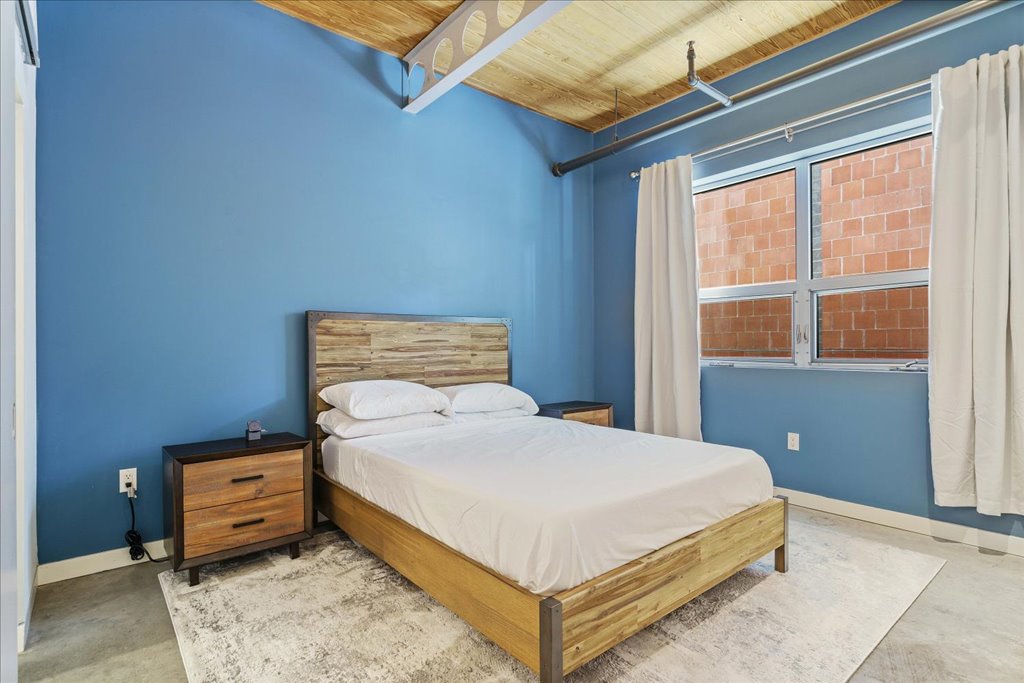 1401 Eva Street, Unit 302 Austin, TX 78704 - Photo 8 of 15 Bedroom with wooden ceiling and concrete floors