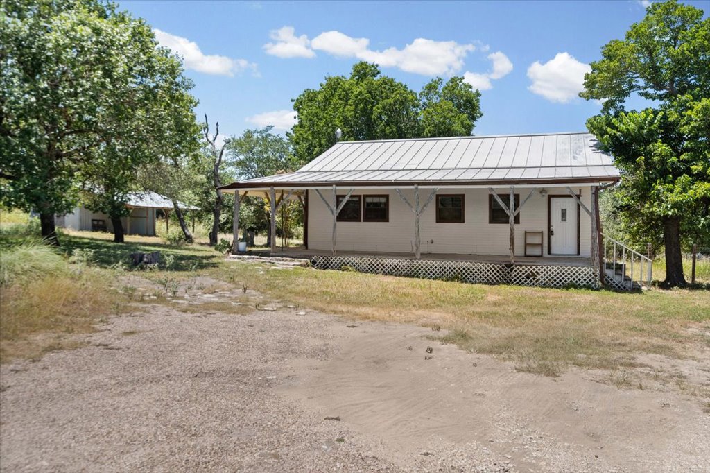 555 Harmon Hills Road, Unit A Dripping Springs, TX 78620 - Photo 8 of 29 Rural retreat with a welcoming covered porch, ideal for peaceful living.