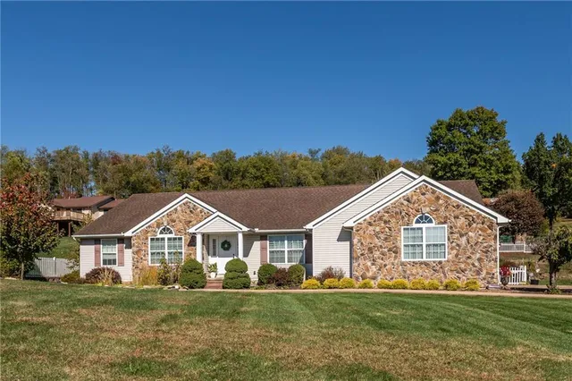 a front view of a house with a yard