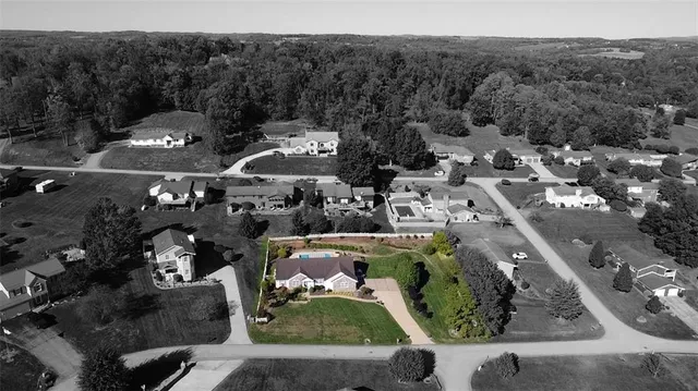 an aerial view of residential houses with outdoor space and street view