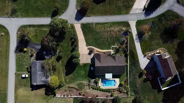an aerial view of residential houses with outdoor space