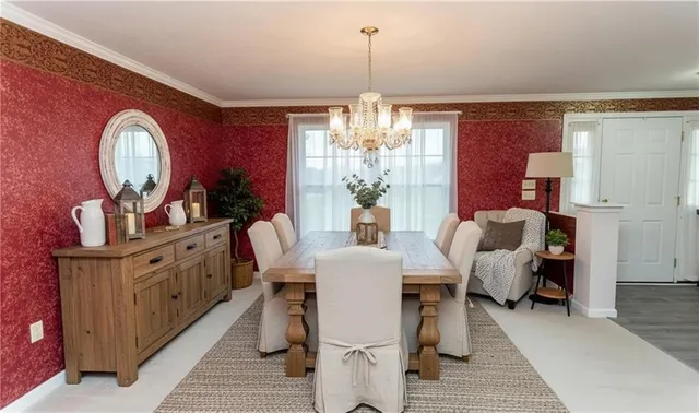 a dining room with furniture a chandelier and window