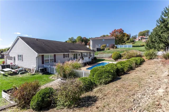 a front view of house with yard and green space