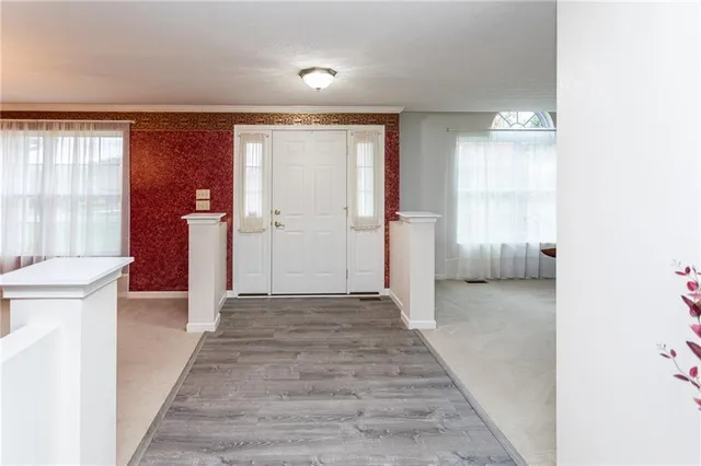 a bedroom with a bed chair and a window