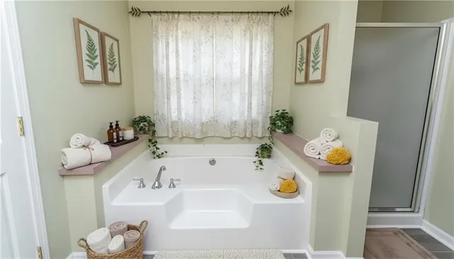 a bedroom with a bed mirror and a window