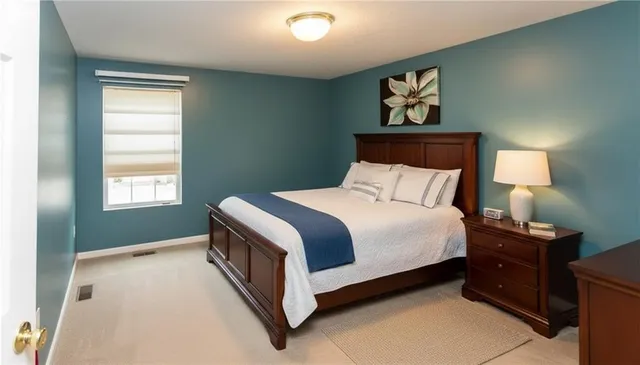 a bathroom with a sink and toilet with wooden floor