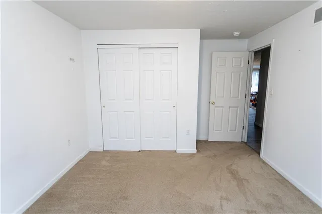 a bathroom with a granite countertop toilet a sink and a mirror
