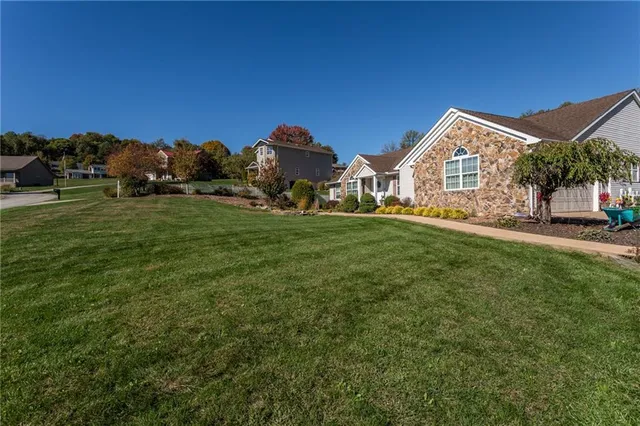 a view of a house with a yard and sitting area