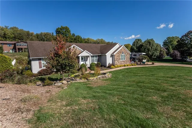 a view of swimming pool with lawn chairs and plants