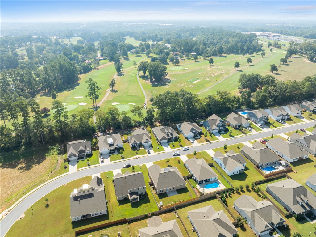 127 Spyglass Lane Pendleton, SC 29670 - Photo 42 of 45 A peaceful residential neighborhood borders a beautifully manicured green golf course under a clear blue sky.