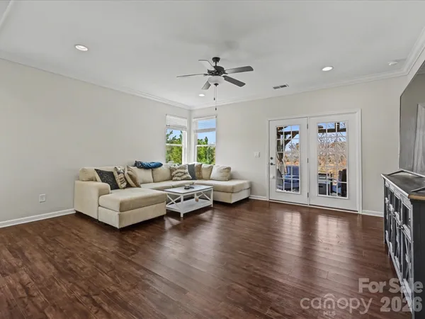 a living room with furniture and wooden floor