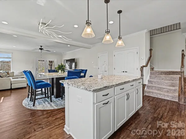 a kitchen with stainless steel appliances granite countertop a stove and a wooden floors