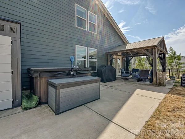 a view of a patio with table and chairs a barbeque