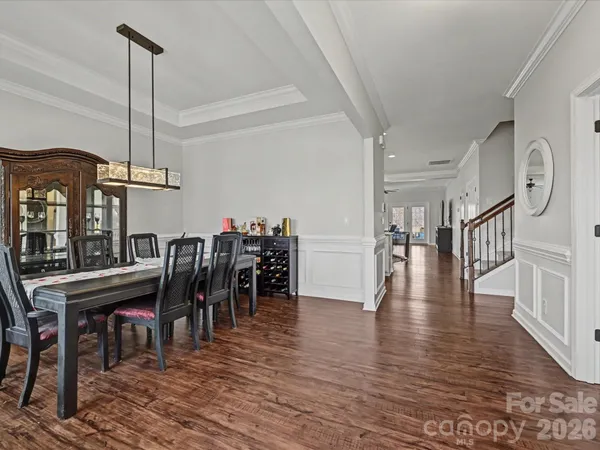 a dining room with furniture entryway and wooden floor