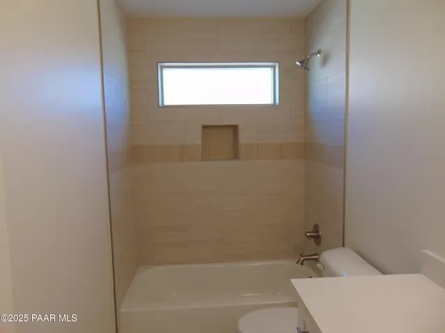 a bathroom with a bathtub sink and vanity