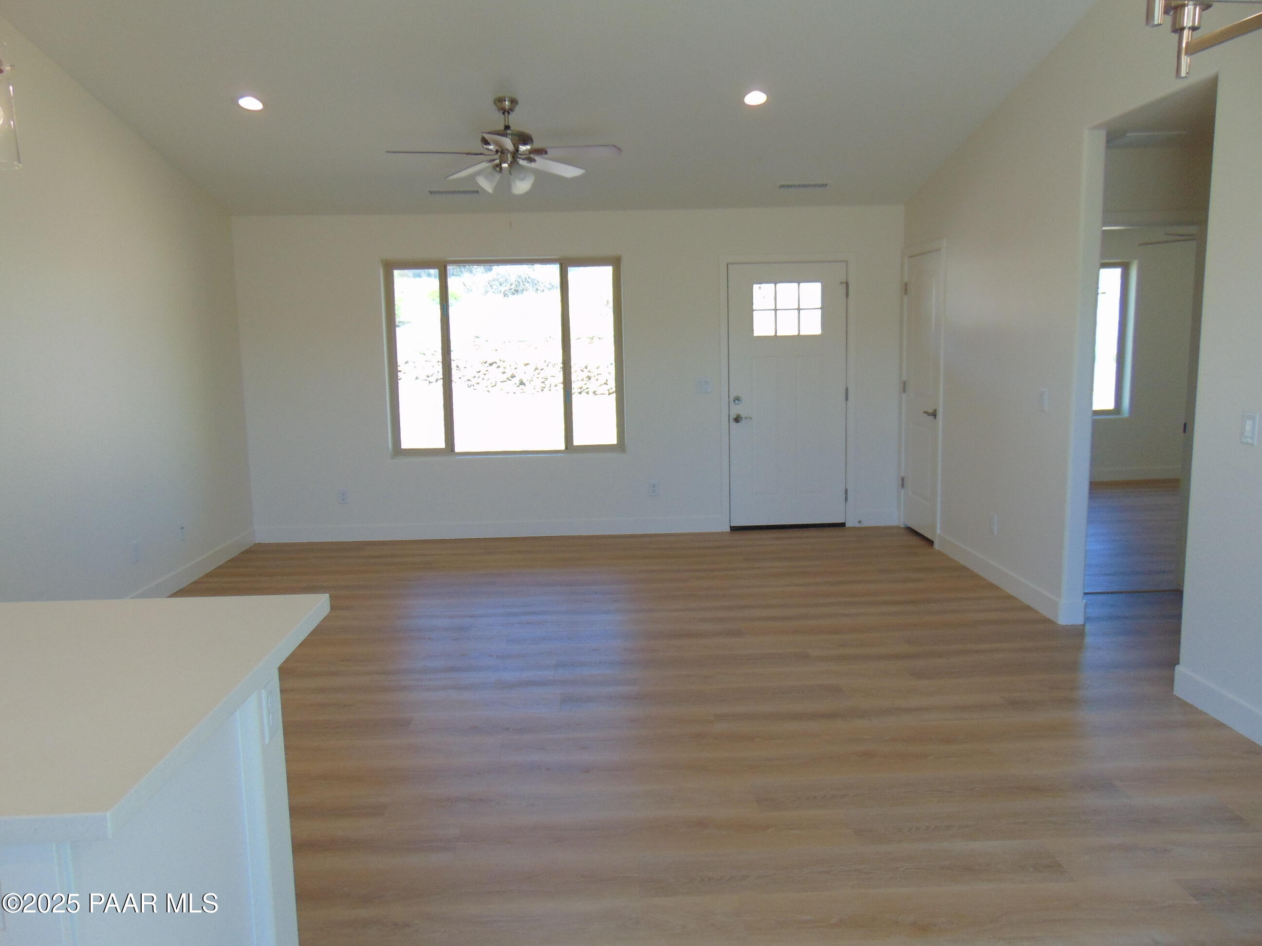 17707 East Jackrabbit Road Mayer, AZ 86333 - Photo 4 of 21 a view of an empty room with window and wooden floor