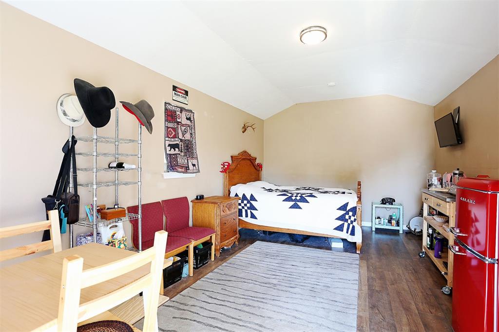 812 Ebenezer Road Palmer, TX 75152 - Photo 18 of 27 a bedroom with furniture and flat screen tv