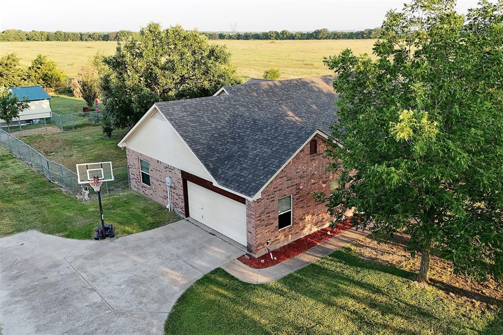 812 Ebenezer Road Palmer, TX 75152 - Photo 4 of 27 a aerial view of a house next to a yard with large tree