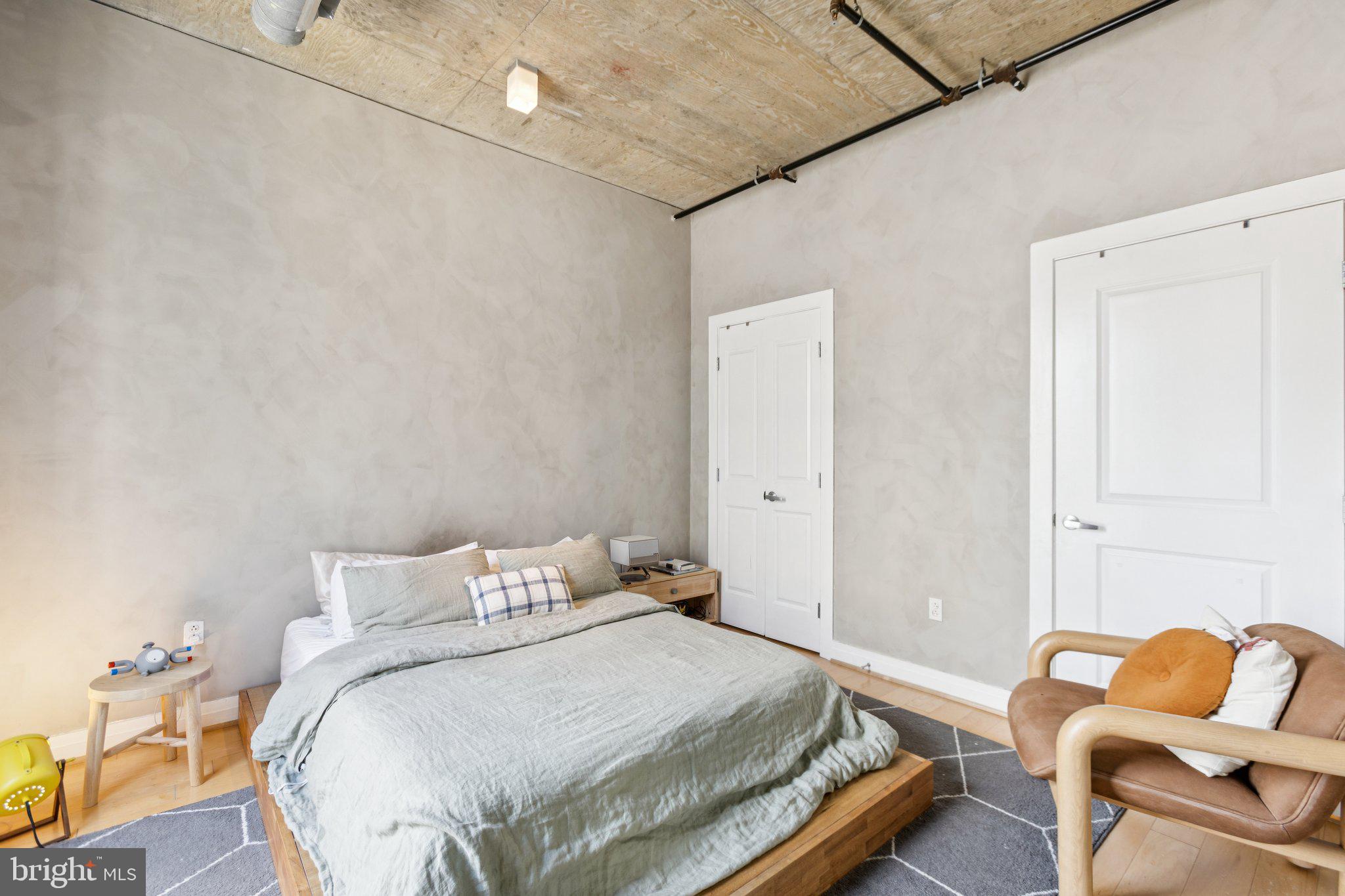 301 Massachusetts Avenue Northwest, Unit 606 Washington, DC 20001 - Photo 13 of 25 a bedroom with a bed and chair