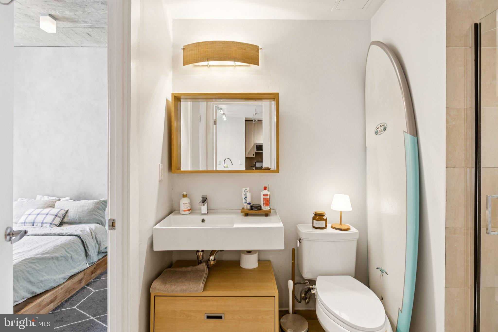 301 Massachusetts Avenue Northwest, Unit 606 Washington, DC 20001 - Photo 17 of 25 a bathroom with a toilet sink and mirror