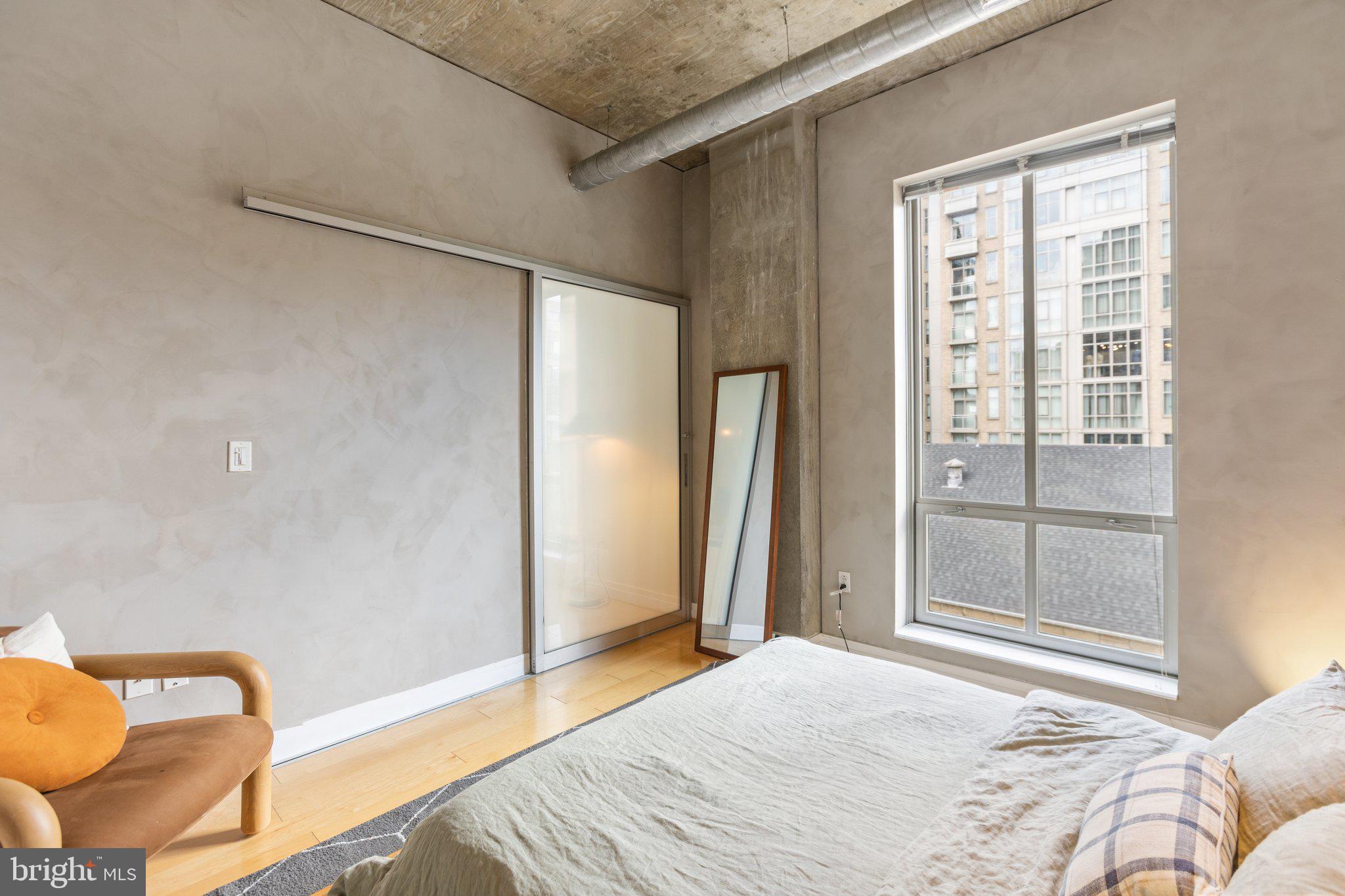 301 Massachusetts Avenue Northwest, Unit 606 Washington, DC 20001 - Photo 18 of 25 a bedroom with a bed and a window