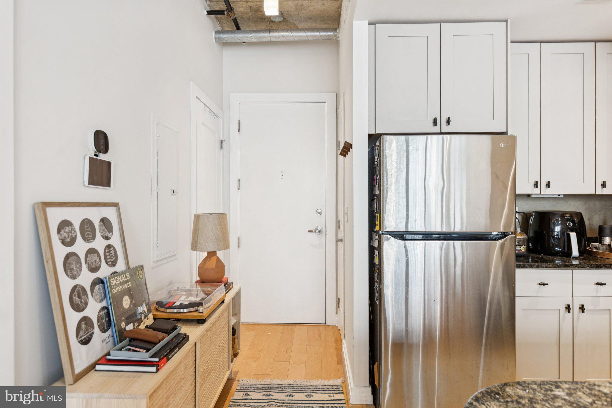 301 Massachusetts Avenue Northwest, Unit 606 Washington, DC 20001 - Photo 5 of 25 a kitchen with stainless steel appliances a refrigerator and cabinets