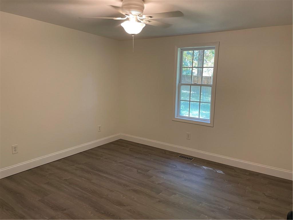 383 Bagwell Road Dawsonville, GA 30534 - Photo 14 of 24 a view of an empty room with wooden floor and a window