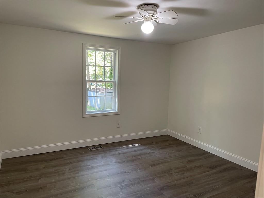383 Bagwell Road Dawsonville, GA 30534 - Photo 15 of 24 a view of an empty room with wooden floor and a window