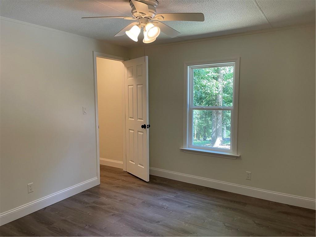 383 Bagwell Road Dawsonville, GA 30534 - Photo 16 of 24 a view of an empty room with wooden floor and a window