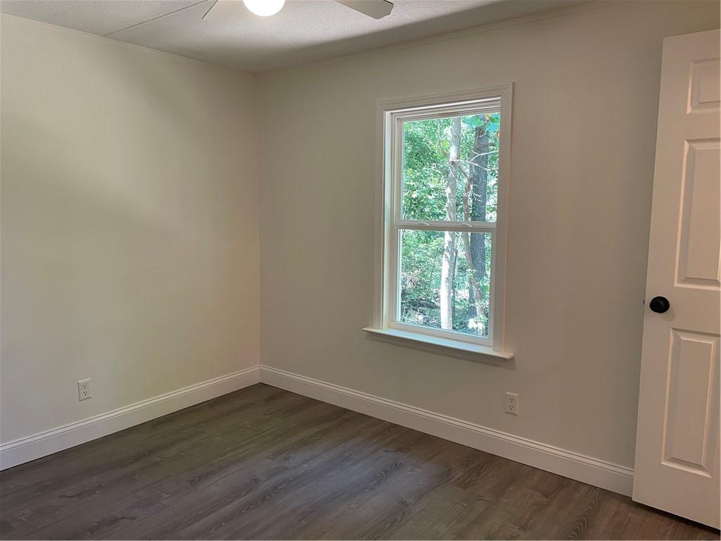 383 Bagwell Road Dawsonville, GA 30534 - Photo 18 of 24 an empty room with wooden floor and windows