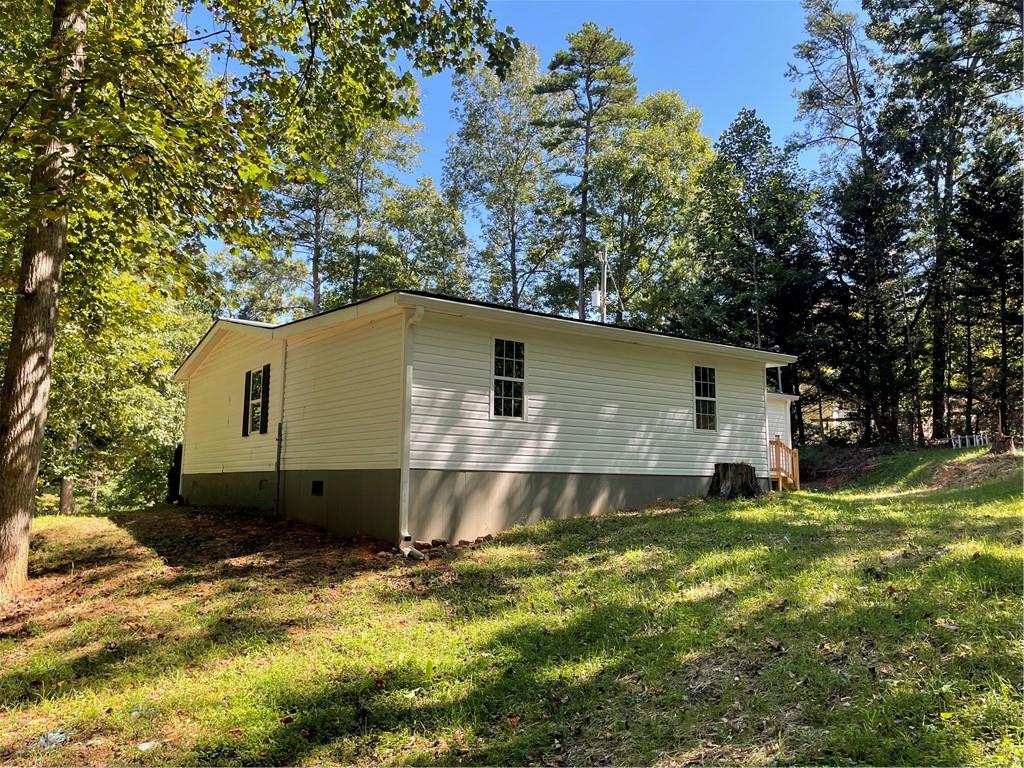 383 Bagwell Road Dawsonville, GA 30534 - Photo 20 of 24 a backyard of a house with large trees and wooden fence