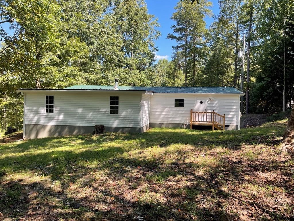 383 Bagwell Road Dawsonville, GA 30534 - Photo 22 of 24 a view of house with backyard