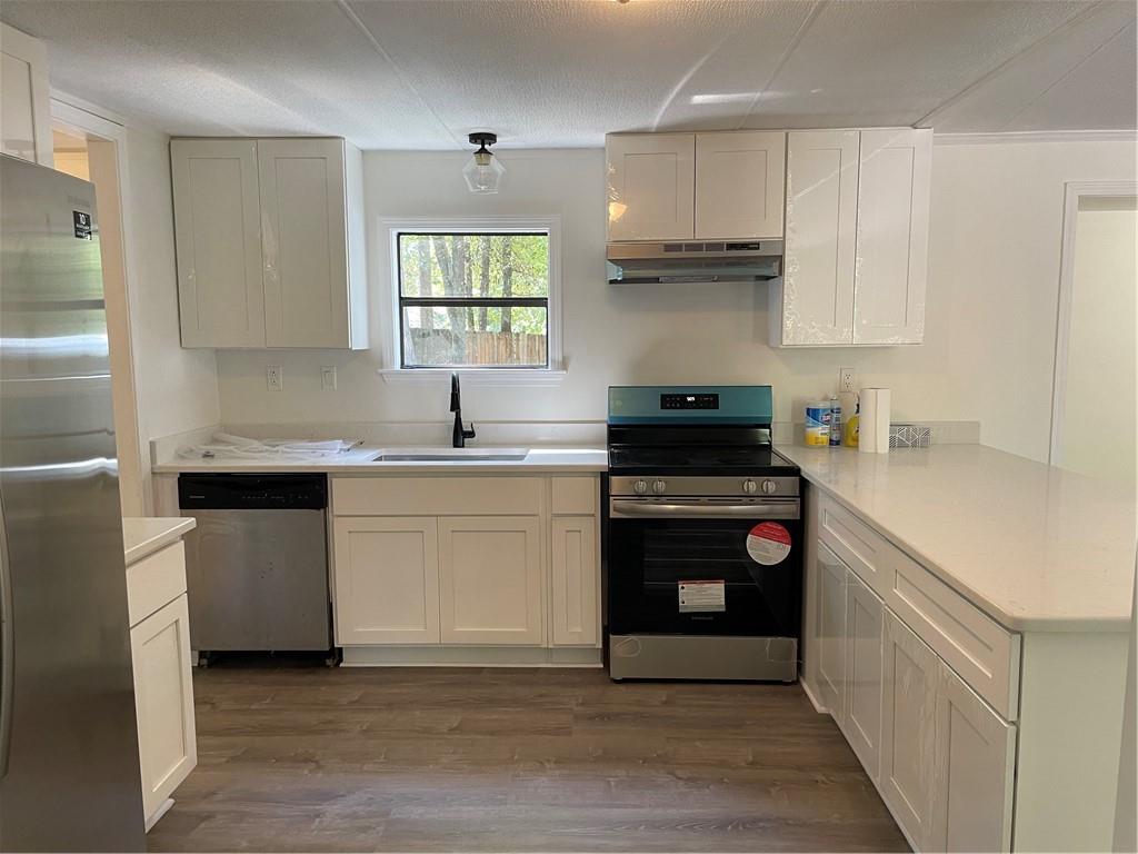 383 Bagwell Road Dawsonville, GA 30534 - Photo 7 of 24 a kitchen with stainless steel appliances granite countertop a sink and a stove