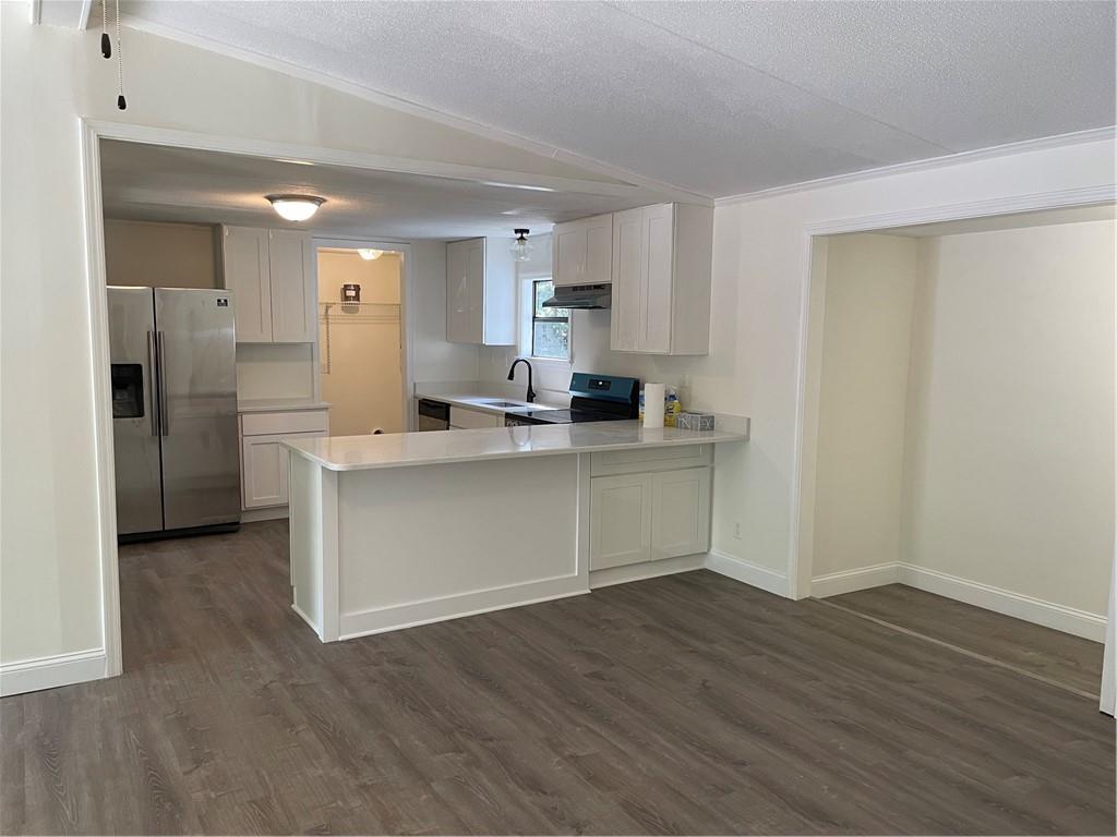 383 Bagwell Road Dawsonville, GA 30534 - Photo 8 of 24 a kitchen with stainless steel appliances kitchen island wooden cabinets and granite counter tops