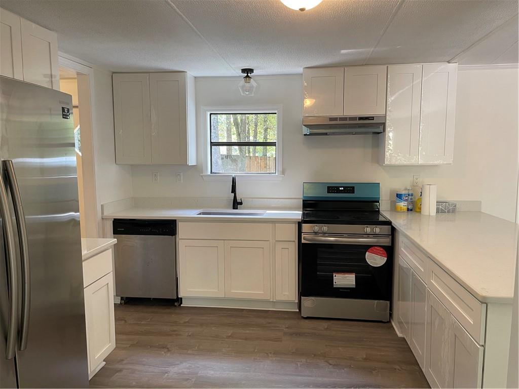 383 Bagwell Road Dawsonville, GA 30534 - Photo 10 of 24 a kitchen with a white stove top oven and white stainless steel appliances