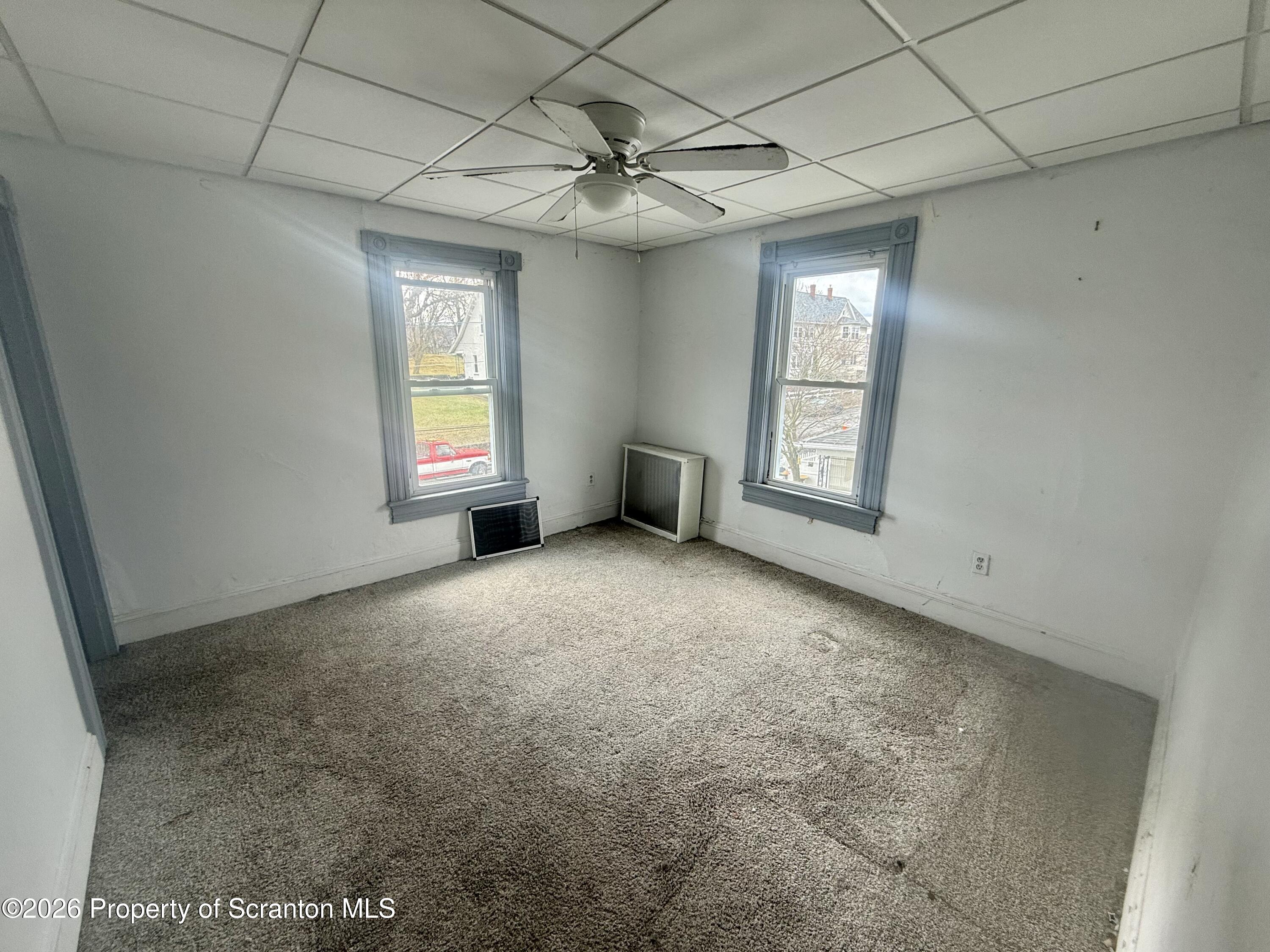 516 4th Street Dunmore, PA 18512 - Photo 6 of 8 en empty room with windows and ceiling fan