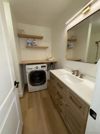 a view of a patio with a table and chairs and potted plants