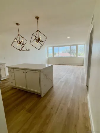 a view of a room with wooden floor and windows